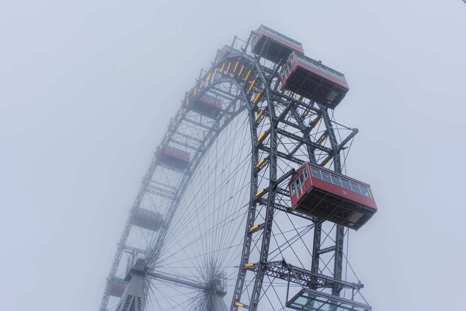 Wiener Riesenrad with red gondolas in dense fog, Prater, Vienna