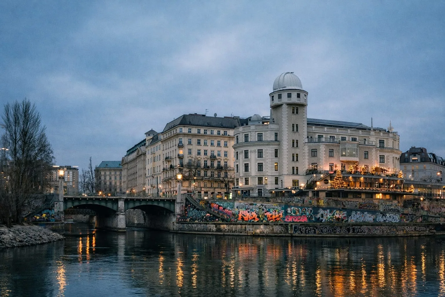 Urania observatory building reflected in the Donaukanal at blue hour, Vienna